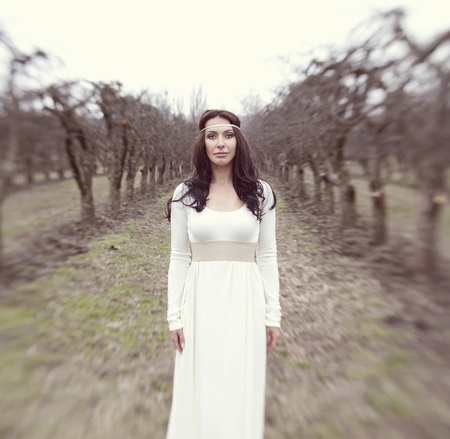 beautiful woman like a princess in a white dress in a fairy forestの写真素材