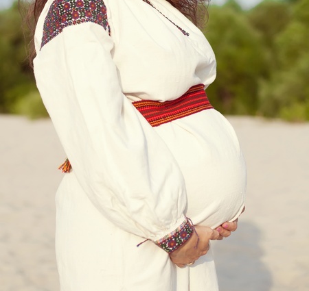 pregnant woman in white dressの写真素材