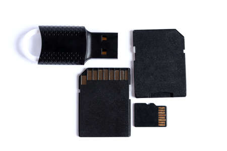 Black memory cards and card reader isolated on white background