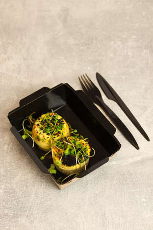 Healthy food delivery concept. Round omelette with vegetables. Restaurant dish delivery in eco paper...