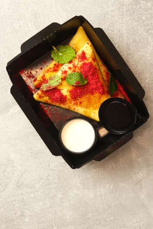 Delicious crepes with raspberry jam and mint on light background, top viewの写真素材