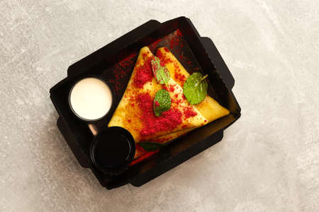 Tasty crepes with berry sauce served on light grey table, top viewの写真素材