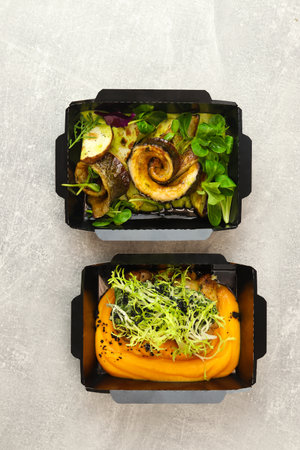 Healthy food plan daily ready menu on black background, fresh meals in paper boxes on gray background as home delivery service in office, flat lay, website photo banner.の写真素材
