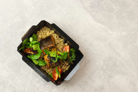 Salmon baked with quinoa and tomatoes. Healthy food, restaurant dish delivery. top view. Free space...