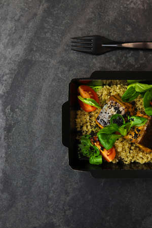 Salmon baked with quinoa and tomatoes. Healthy food, restaurant dish delivery. top view. Free space for your text.の写真素材