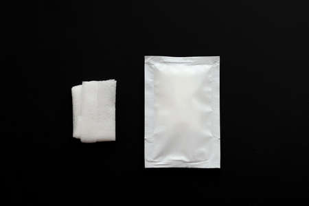 Blank white sachet packets stack mockup isolated on black background. Empty airtight pack mock-up for wet wipe.の写真素材