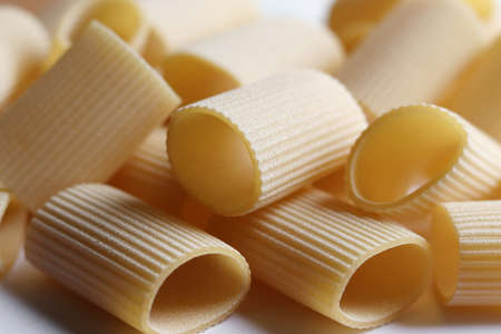 Raw paccheri background. Texture of traditional Italian pasta