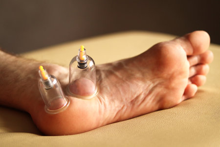 cupping therapy. Cup vacuum massage. Cups for massage on the man's foot.の写真素材