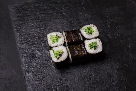 Close-up of maki sushi rolls with cucumber on black backgroundの写真素材