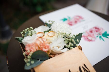 Wedding bridal bouquet of flowers and sring on a table. Close up.の写真素材
