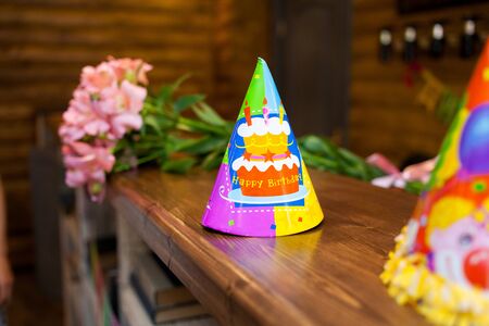 Birthday hat on the table decorated for children's celebration party. Close up