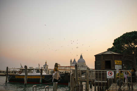 Romantic scenery of the Grand Canal in Venice in a relaxing atmosphere under beautiful blue sunny sky. A leisure and relaxed moment in Venezia Italyのeditorial素材