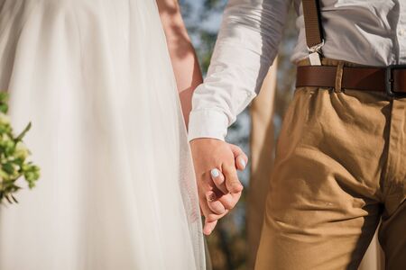 Wedding couple hands gently touching. Close up. Vertical photo.の写真素材