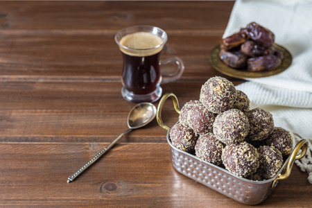 Dates and oatmeal energy balls or bites no cook with espresso black coffee on wooden table healthy food concept for iftar or suhoor  ramadan with copy spaceの写真素材
