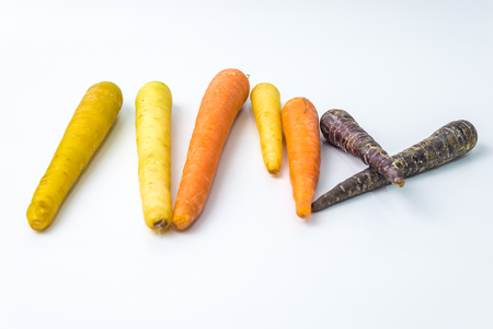 colourful organic carrots on white background with copy spaceの写真素材