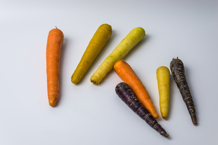 colourful organic carrots on white background with copy spaceの写真素材