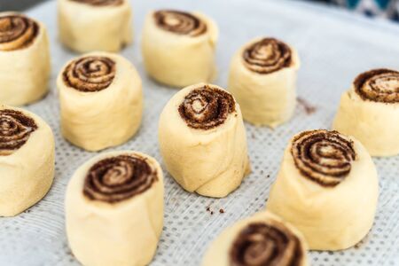 mother preparing a dough for cinnamon rolls at the kitchen