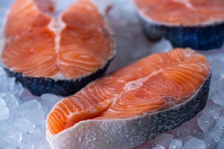 Raw fresh salmon fillet on ice cubes. Side view, closeupの写真素材