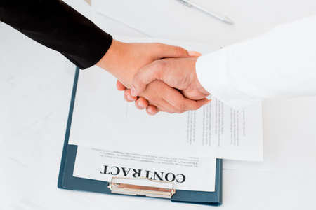 Close-up of hands signing contract agreementの写真素材