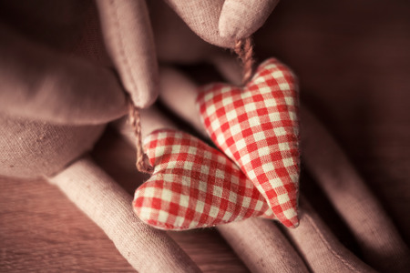 Couple handmade linen toys with red hearts. Easter and Valentine Day holiday concept. Wedding theme.
