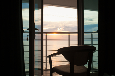 Beautiful view of the sea and sky line from chair on balkony in hotel room.の写真素材