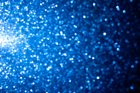 Christmas and New Year holidays blue colour blurred background. Beautiful sparkling texture for all holidays. Selective focuse.の写真素材