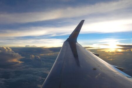 Silhouette at sunset on air planeの写真素材
