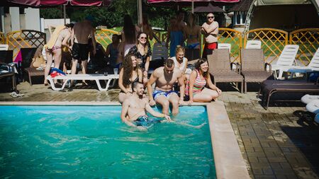 Employees of IT-company, the summer of 2018, A group of young people having fun in the pool and swimming, drinking cocktails by the pool and laughing. Editorial, illustrative, illustrative editorのeditorial素材