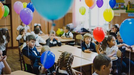 Zaporozhye, Ukraine - September 1, 2018: Blurred background of children in school uniform sitting in...
