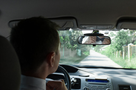 Groom's necktie in the mirror in the wedding car