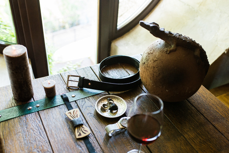 Men's leather belt and other groom's accessories on a wooden tableの写真素材
