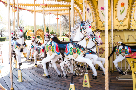 Carousel with horses in a children's amusement park.の写真素材