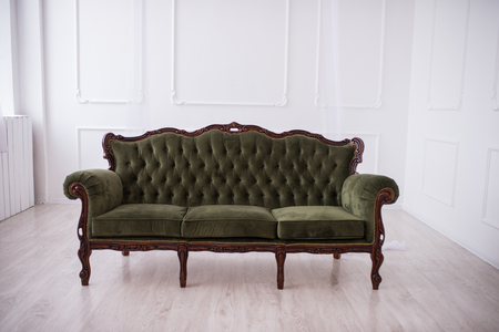 Green sofa on white wall background. Indoorsの写真素材