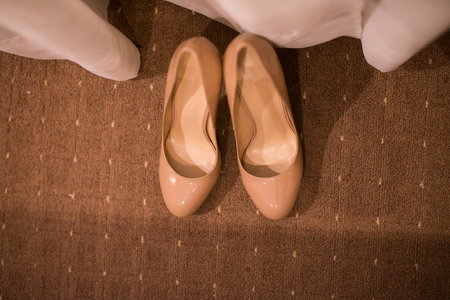 Pair of elegant bride's beige shoesの写真素材