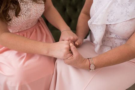 Adult mom and daughter holding handsの写真素材