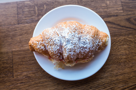 Croissant sandwich sprinkled with powdered sugar. Fast snack foodの写真素材