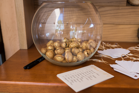 Golden walnut in a glass round vase. Wedding decorの写真素材