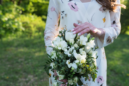 Bride touching wedding bouquet with her hand. Wedding detailsの写真素材