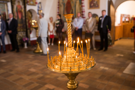 Burning wax candles in a candlestick in the Orthodox church.の写真素材