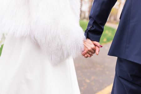 Happy couple holds hands of each other. Wedding day. Concept of union, support and future.の写真素材