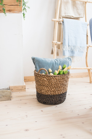 Wicker basket with green tulips. Homeの写真素材
