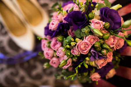 Wedding bouquet with purple and pink roses, violet flowers close up.の写真素材