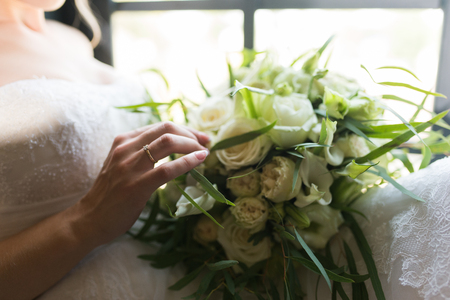 Bride touching wedding bouquet with her hand. Wedding detailsの写真素材