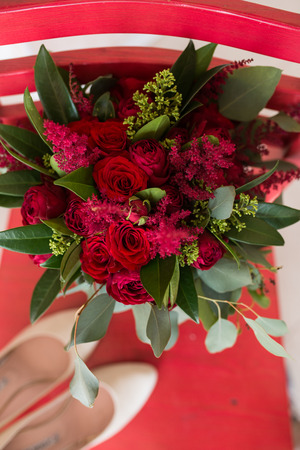 Wedding. Lush bridal Bouquet of red roses and a lot of greeneryの写真素材