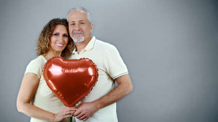 A cheerful mature couple in casual attire celebrates an event, Valentines Dayの写真素材