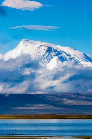 View of Gurla Mandhata peak towering over sacred lake Manasarovar in western Tibet, Chinaの写真素材
