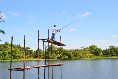 Man on structure throwing fishing rod in Laguna del Fear in Yondo Antioquia