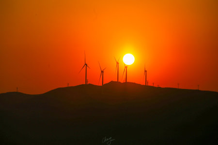 Sunset over wind turbines in the desert, north china.の写真素材