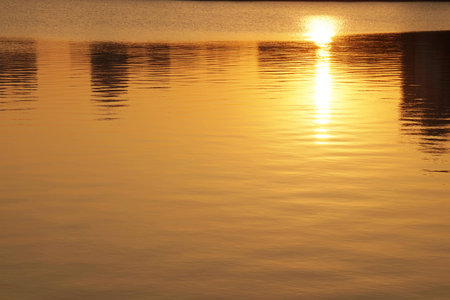 The lake surface under the sunsetの写真素材