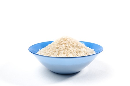 handful of long-grain rice isolated in the blue cup on centerの写真素材